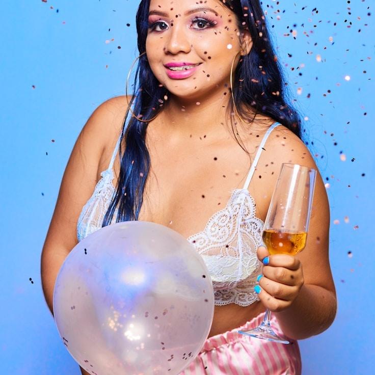 Ava Singh, Lead Design Curator at Moonlit Forest Path, reviewing corporate floral arrangements